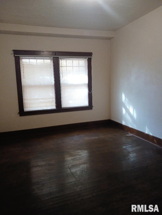 unfurnished room with dark hardwood / wood-style floors