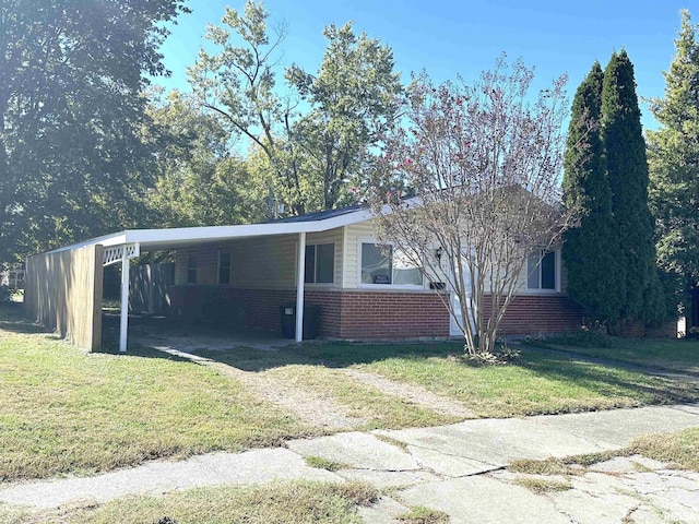 1911 Wall St, Murphysboro, IL 62966 - view of front of property featuring brick siding, driveway, a front yard, and a carport
