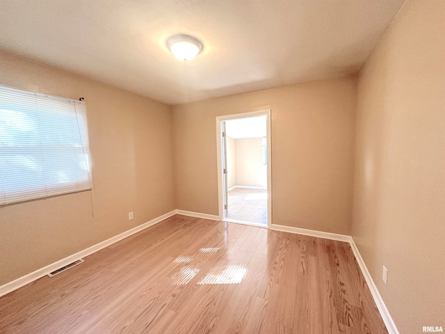 unfurnished room with hardwood / wood-style floors