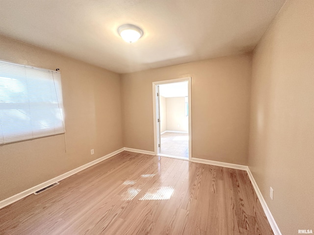1911 Wall St, Murphysboro, IL 62966 - unfurnished room featuring visible vents, light wood finished floors, and baseboards
