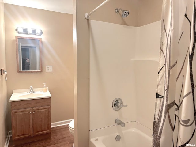 full bathroom featuring toilet, vanity, wood-type flooring, and shower / tub combo