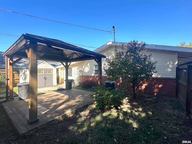 back of property featuring a gazebo, a storage unit, and cooling unit