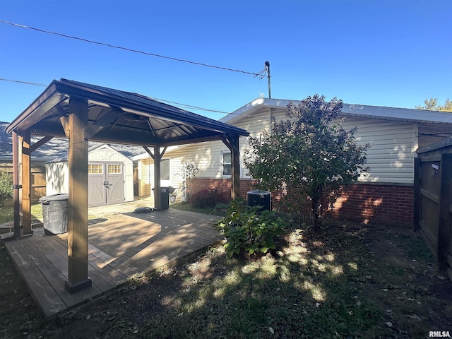 1911 Wall St, Murphysboro, IL 62966 - back of property featuring an outdoor structure, central AC, a deck, a shed, and a gazebo