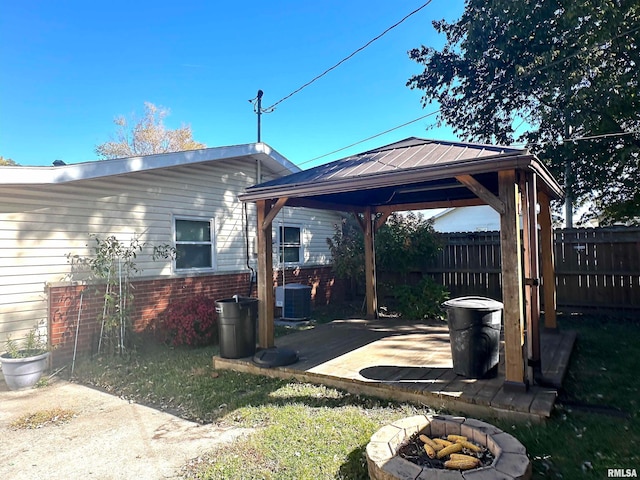 view of yard featuring a gazebo, a fire pit, central AC unit, and a patio