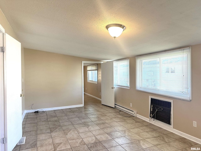 1911 Wall St, Murphysboro, IL 62966 - empty room featuring baseboards, a baseboard radiator, and a textured ceiling