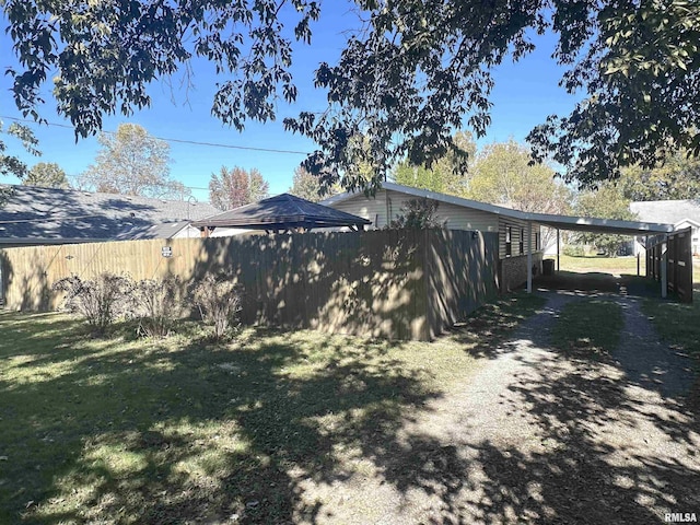 1911 Wall St, Murphysboro, IL 62966 - exterior space with fence, an attached carport, and driveway