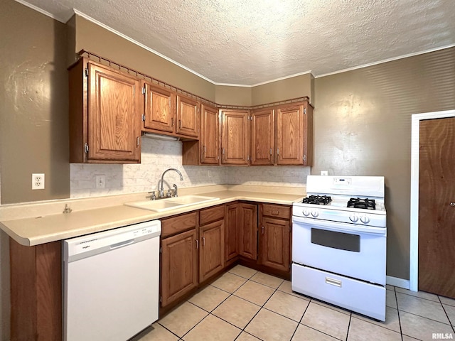 kitchen with a textured ceiling, sink, light tile patterned floors, and white appliances