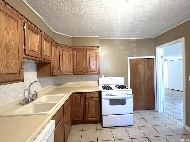 1911 Wall St, Murphysboro, IL 62966 - kitchen featuring white appliances, a textured ceiling, brown cabinetry, and a sink
