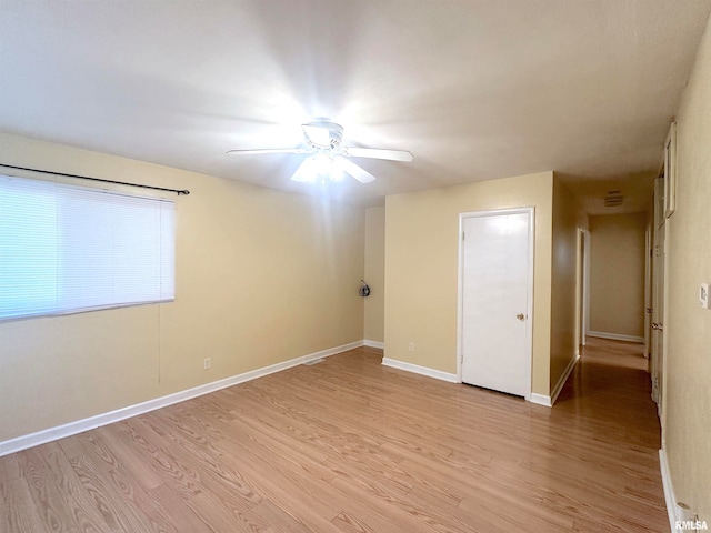 empty room with light hardwood / wood-style floors and ceiling fan