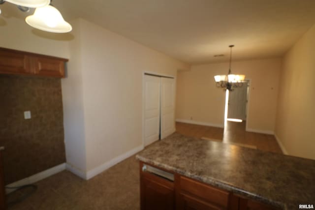 kitchen with a notable chandelier and hanging light fixtures