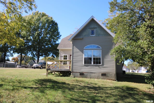 exterior space with a wooden deck and a lawn