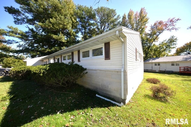 view of side of property with a yard