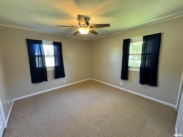 carpeted empty room with ornamental molding, a textured ceiling, a healthy amount of sunlight, and ceiling fan