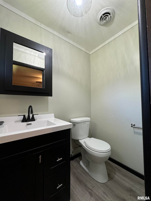 bathroom with vanity, a textured ceiling, hardwood / wood-style flooring, and toilet