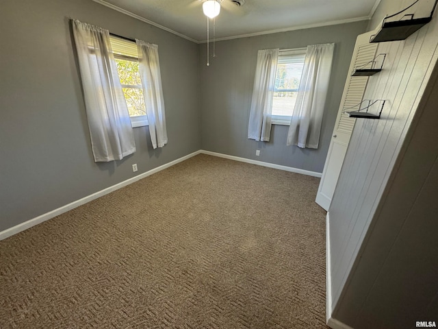 unfurnished room featuring ceiling fan, carpet flooring, and ornamental molding