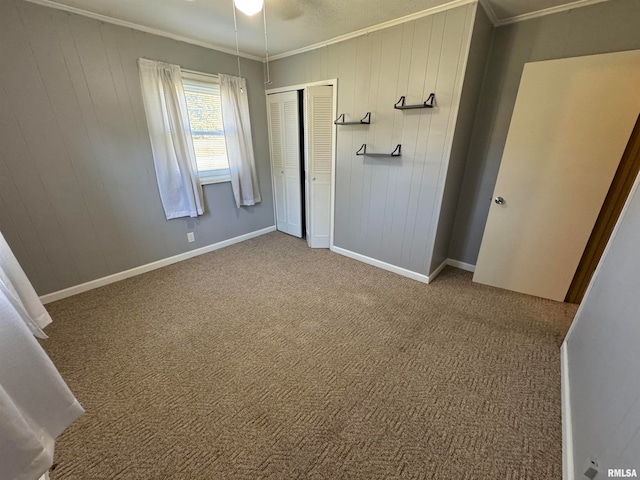 unfurnished bedroom with a closet, ornamental molding, and carpet