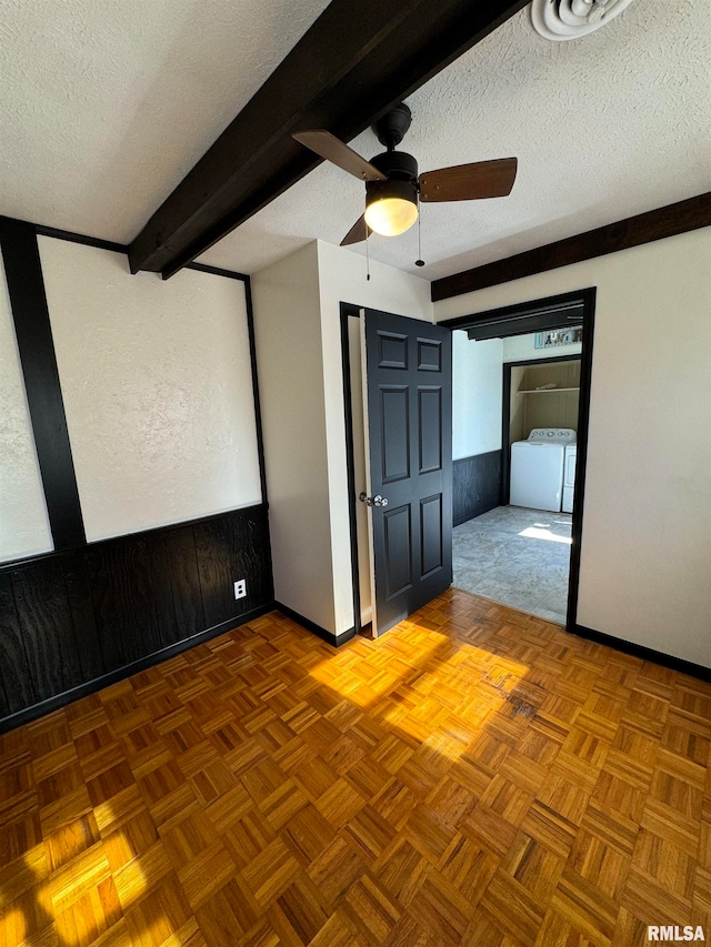 unfurnished bedroom featuring beam ceiling, a textured ceiling, and ceiling fan