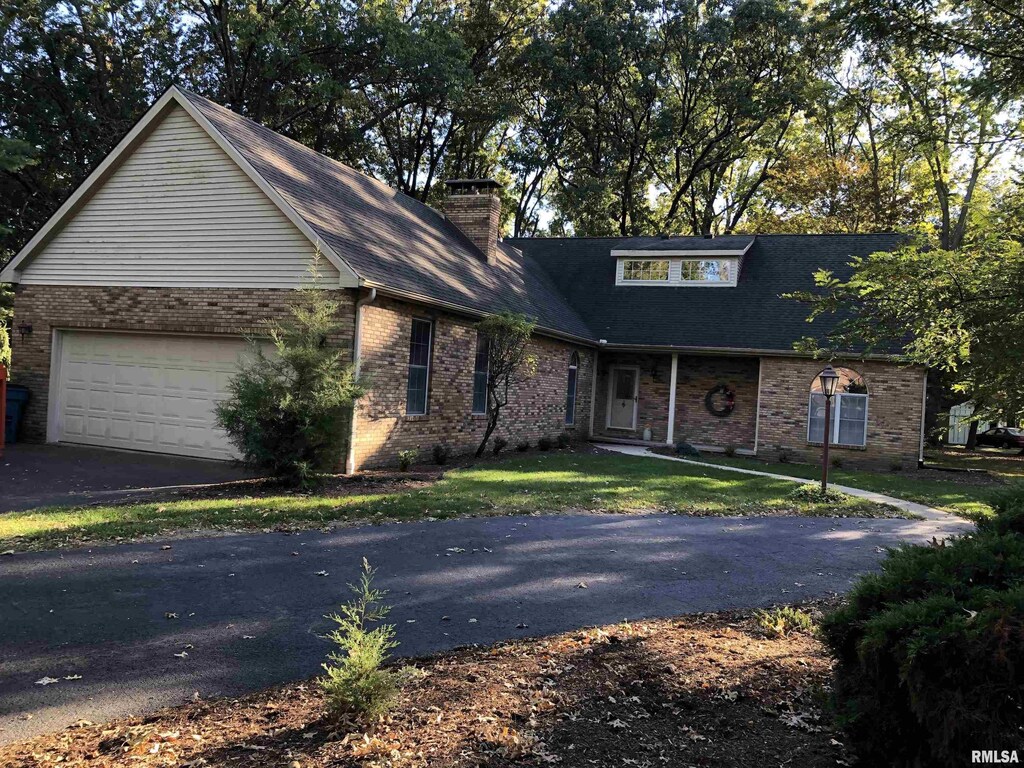 2707 Richview Rd, Mount Vernon, IL 62864 - view of front of property with a garage, brick siding, and driveway