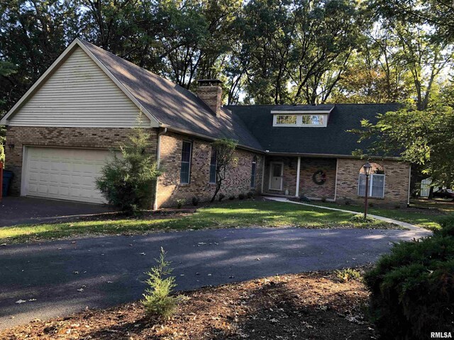 2707 Richview Rd, Mount Vernon, IL 62864 - view of front of property with a garage, brick siding, and driveway