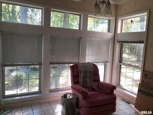 living area with a healthy amount of sunlight and light tile patterned floors