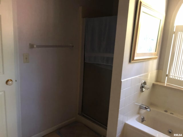 bathroom with separate shower and tub