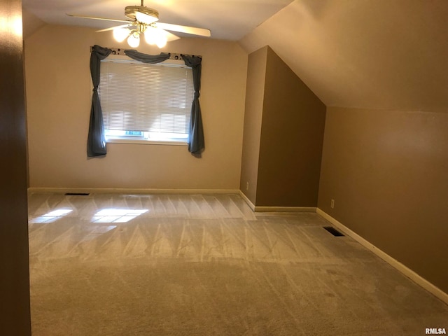 additional living space featuring lofted ceiling, light colored carpet, and ceiling fan