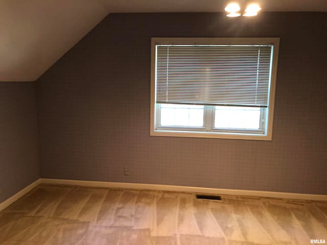 bonus room featuring carpet floors and vaulted ceiling