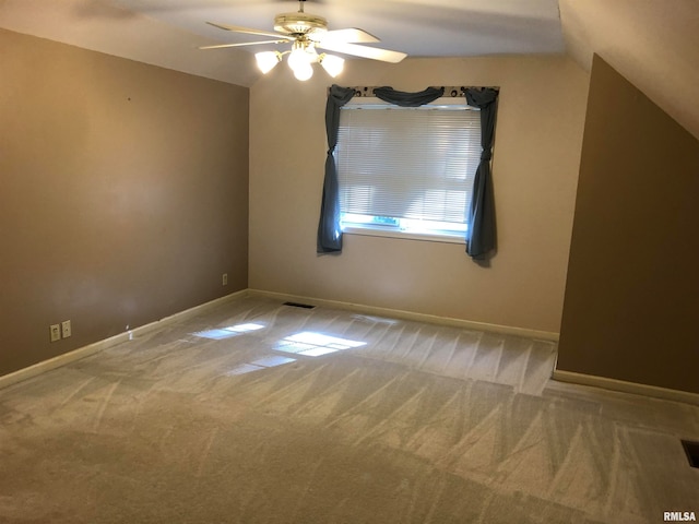 spare room with ceiling fan, carpet, and lofted ceiling