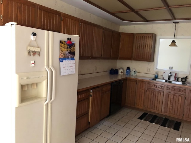 kitchen featuring black dishwasher, light tile patterned floors, white fridge with ice dispenser, sink, and decorative light fixtures