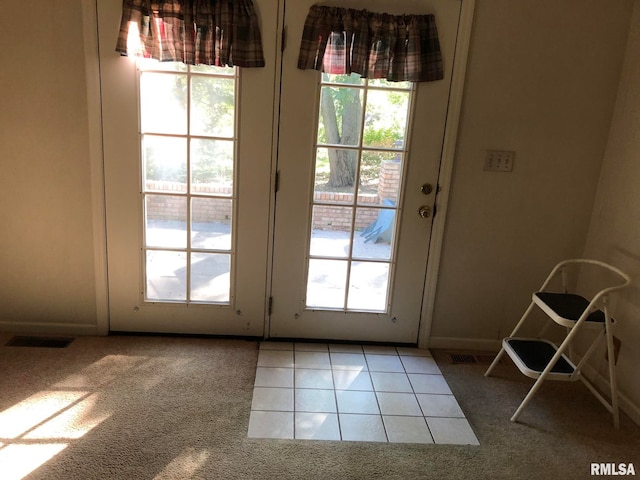 doorway to outside with a healthy amount of sunlight and carpet floors