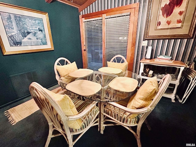 dining space with lofted ceiling and carpet floors