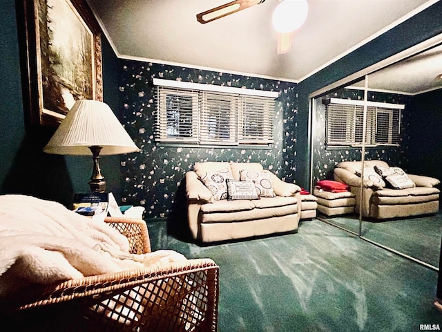 living room with ornamental molding, carpet floors, and ceiling fan