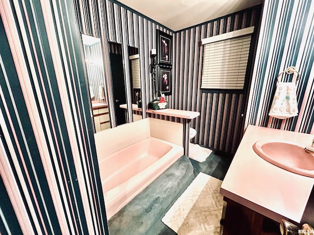 bathroom with vanity, a tub to relax in, wood-type flooring, and toilet