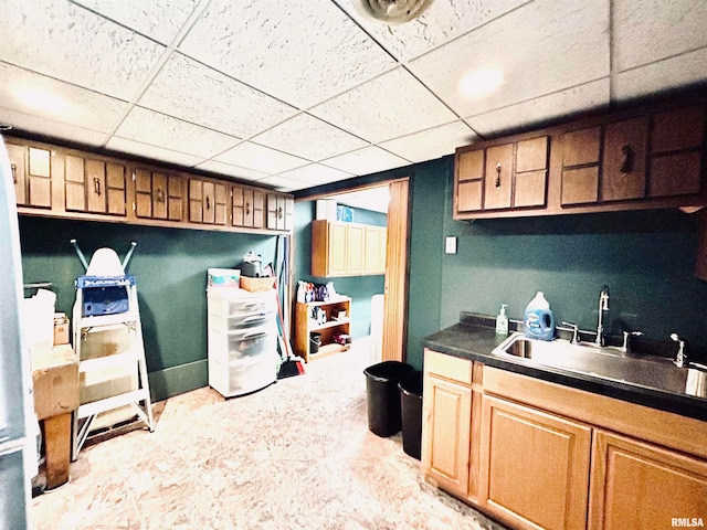 kitchen featuring a drop ceiling and sink