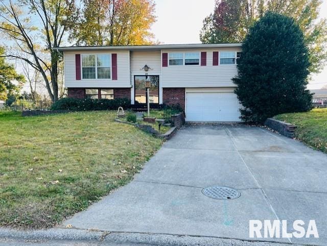 raised ranch featuring a front lawn and a garage