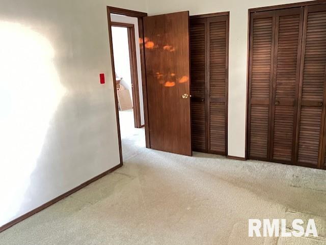 25 SW Crescent Rd, Mount Vernon, IL 62864 - unfurnished bedroom featuring two closets, carpet flooring, and baseboards