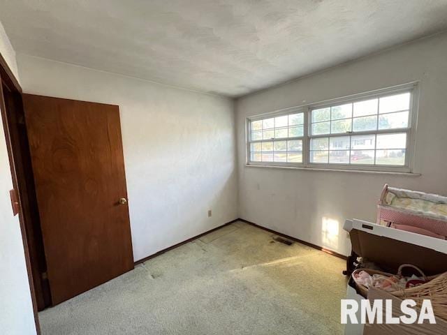 empty room featuring light carpet