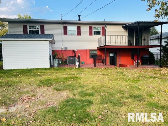 rear view of house featuring a yard, a wooden deck, and central AC unit