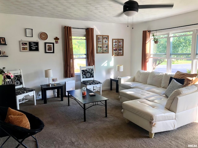 carpeted living room with a textured ceiling and ceiling fan