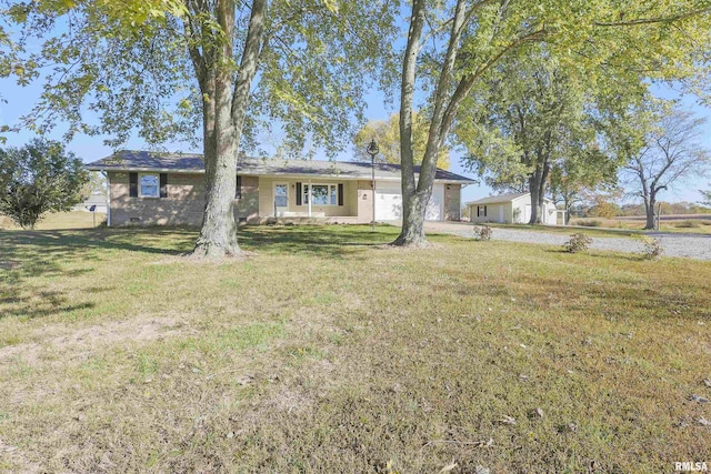 view of front of property with a front yard and a garage