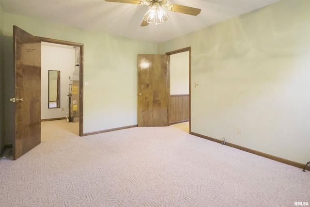 unfurnished bedroom featuring light colored carpet and ceiling fan