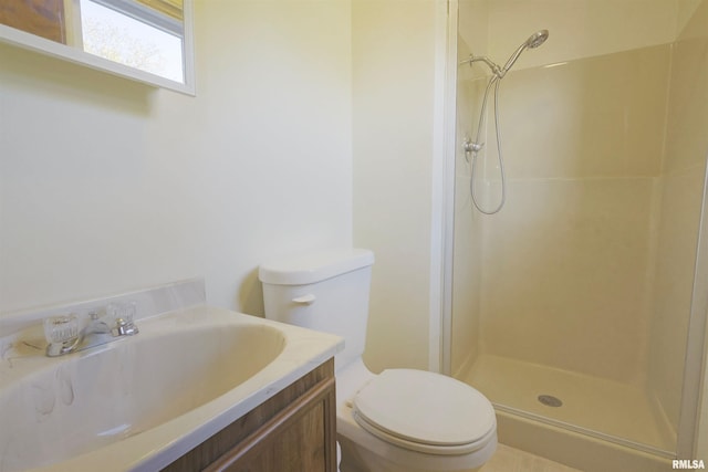 bathroom with toilet, vanity, and a shower