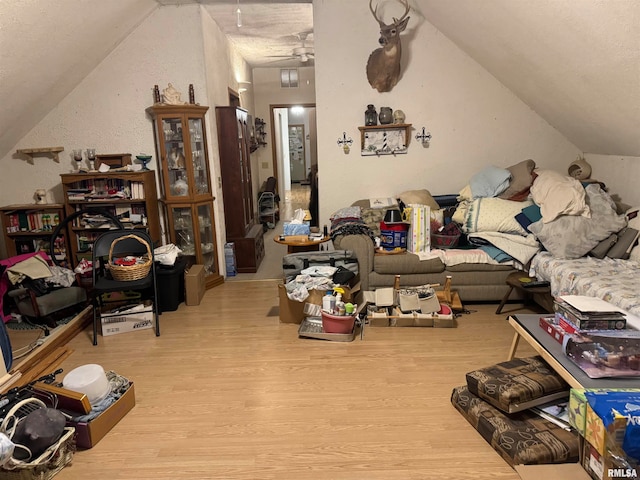 living room with lofted ceiling and light wood-type flooring