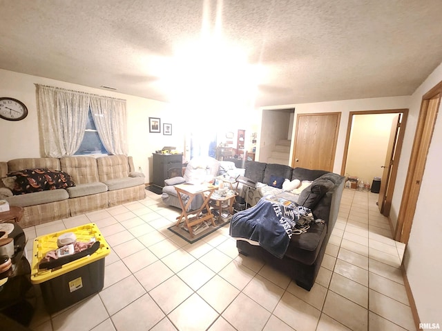 living room with a textured ceiling and tile patterned flooring