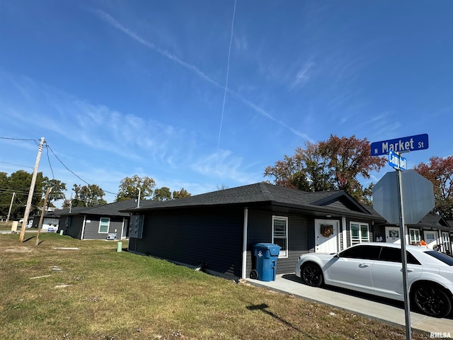 view of side of property with a yard