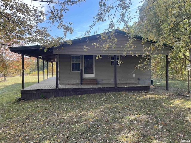 back of property featuring a yard