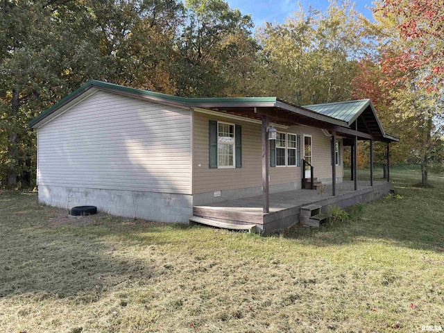 view of side of property with a lawn and a porch