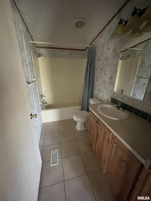 full bathroom featuring tile patterned floors, shower / tub combo with curtain, vanity, and toilet