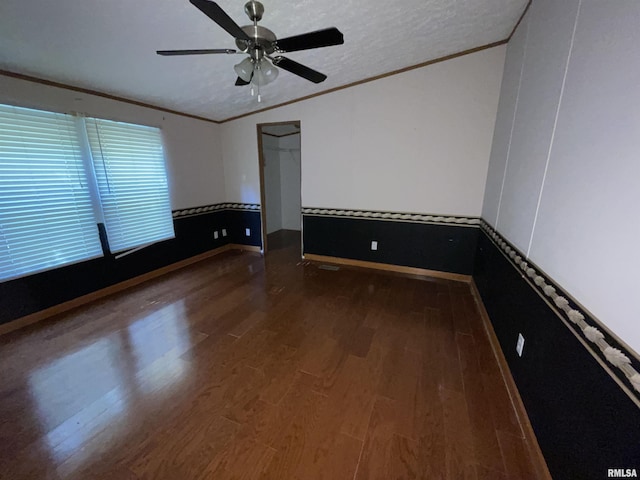 empty room with hardwood / wood-style flooring, ceiling fan, crown molding, and a textured ceiling