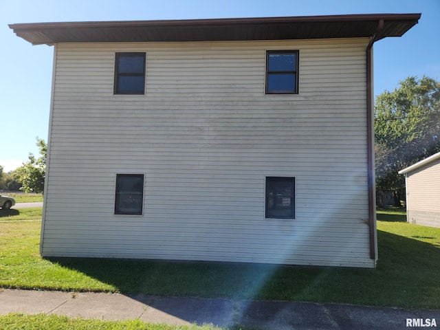 view of side of home with a lawn